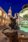 Night view of the Basilica of the Holy House and fountain decorated with statues Loreto Province of Ancona Marche Italy Europe