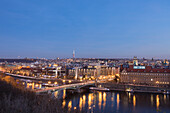 Dusk lights up the historical bridges and buildings reflected on Vltava , Moldava, river Prague Czech Republic Europe