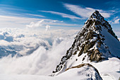 Mountain top over the clouds, Mittagorn group, Valais, Switzerland