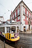 Yellow tram number 28 performs the longest route leading from centre of town up to the top of Alfama Lisbon Portugal Europe