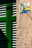 Beside many front doors you find tiles with representations from the life of the island saint Catalina Thomás, Valldemossa, Mallorca, Spain