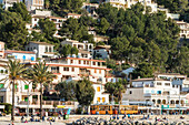 View from the harbour at the promenade with the old tram and the surrounding homes, Port de Sóller, Mallorca, Spain