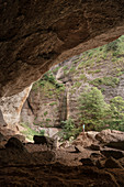 ' hiker stands inside the natural wonder called ''Ofenloch'', canton St. Gallen, Switzerland, Europe'