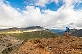 Hiker on the war trenches on rocky peaks, Filon Del Mott, Bormio, Braulio Valley, Stelvio Pass, Valtellina, Lombardy, Italy, Europe