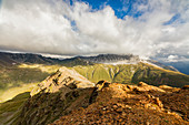Sun and clouds on the rocky crest of the Alps, Filon del Mott, Bormio, Braulio Valley, Stelvio Pass, Valtellina, Lombardy, Italy, Europe