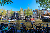 Bicycles parked on the banks of the river Amstel and typical houses, Amsterdam, Holland (The Netherlands), Europe