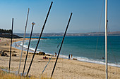 Beach seen though masts of beached boats, Mossel Bay, Western Cape, South Africa, Africa