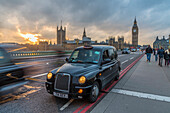 Sunset over a taxi and Big Ben on Westminster Bridge, London, England, United Kingdom, Europe