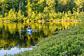 A Man Kayaking On Round Pond In Barrington, New Hampshire