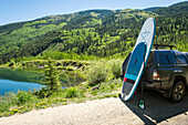 Getting ready to paddleboard on an alpine lake in Colorado during the spring