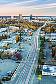 Aerial view of downtown Anchorage in autumn with Denali in the background at sunset, Southcentral Alaska, USA