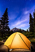 'Tent and milky way visible in the sky over Teton Range, Grand Teton National Park; Wyoming, United States of America'