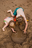 High Angle View of Two Young Children Playing in Sand at Beach