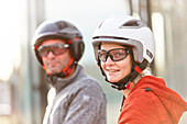 Man and woman with eBike Helmet, eBikes, City,  Munich, Bavaria, Germany