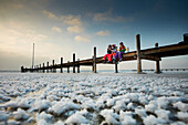 Kids on a jetty on frozen Lake Starnberg, Ambach, upper Bavaria, Bavaria, Germany