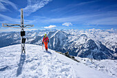 Woman backcountry skiing standing at summit of Grosses Mosermandl, Grosses Mosermandl, Radstadt Tauern, Carinthia, Austria