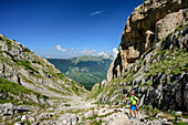 Woman hiking ascending towards Monte Amaro, Monte Amaro, Majella, Abruzzi, Italy