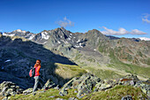 Woman hiking looking towards Stubai Alps and valley of Gleirschtal, Satteljoch, Lampsenspitze, Sellrain, Stubai Alps, Tyrol, Austria