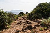 Rocky hiking trail with ocean view of Favignana island, Levanzo Island, Aegadian Islands, near Trapani, Sicily, Italy, Europe