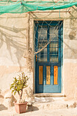 Blue door with fishing nets as shading, Levanzo Island, Aegadian Islands,near  Trapani, Sicily, Italy, Europe