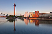 Full moon, television tower and Neuer Zollhof (Architect: F.O. Gehry), Medienhafen, Duesseldorf, North Rhine-Westphalia, Germany