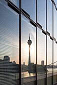 Television tower and Neuer Zollhof (Architect: F.O. Gehry) reflecting in the facade of the Hyatt Regency Hotel, Medienhafen, Duesseldorf, North Rhine-Westphalia, Germany