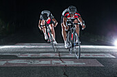 Young men having a race with their racing cycles in the Kitzbühler Alps, Kitzbühlerhorn, Tyrol, Austria