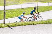 Two people on their racing cycles in the Kitzbühler Alps, Kitzbühlerhorn, Tyrol, Austria