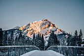 Man standing on a bridge, Banff, Banff National Park, Alberta, winter, snow, mountains, Canada, North America