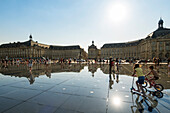 Der Wasserspiegel (Miroir d'eau) vor dem Place de la Bourse mit spielenden Kindern, Bordeaux, Gironde, Nouvelle-Aquitaine, Frankreich, Europa