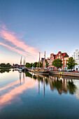 View over river Trave at sunset towards old town, Luebeck, Baltic coast, Schleswig-Holstein, Germany