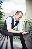 Businessman using digital tablet outdoors