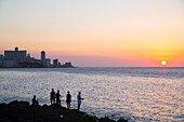 Locals fishing from the Malecon in the evening, Centro Habana, Havana, Cuba, West Indies, Central America
