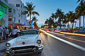 Ocean Drive restaurants, vintage car and Art Deco architecture at dusk, South Beach, Miami Beach, Miami, Florida, United States of America, North America