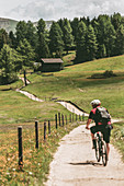 Alpe di Siusi/Seiser Alm, Dolomites, South Tyrol, Italy, Biker on the path