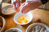 a chef is preparing a traditional local food with eggs, Bolzano province, South Tyrol, Italy