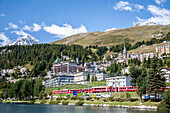 The Bernina Express passing by Saint Moritz, Engadine, Switzerland Europe