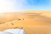 Jeep on the sand dunes modeled by wind Walvis Bay Namib Desert Erongo Region Namibia Southern Africa