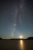 Moonset over Lunar Lake. Lunar Lake is a dry lake bed that glistens with reflected light.