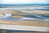 Mudflats surrounding Mont-Saint-Michel at low tide, Normandy, France