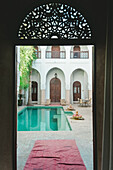 Empty swimming pool in courtyard of Moroccan riad, Marrakech, Morocco