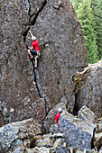 Rock climber climbing cliff, Whistler, British Columbia, Canada