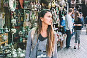 Female tourist walking in Jemaa el-Fnaa souk in Marrakesh, Morocco