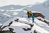 Two Skiers Walking On A Ridge In The French Alps