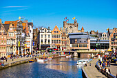 Gravensteen Castle And Buildings Along The Leie River And Korenlei Quay