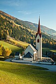 Autumn morning at the iconic alpine church in Winnebach, South Tyrol, Italy.