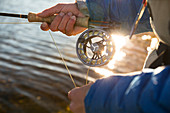 Angler fishing with his Orvis fly reel