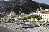 Italy, Amalfi Coast, Landscape, panorama, Amalfi's shingle beach. Amalfi is a small town whose high white houses are perched on the slopes of the hills in front of a deep blue sea.