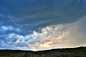 France, Normandy. Annoville. The dunes and the beach. Beginning of a storm. Lightning in the sky