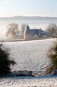 Old oast house in winter frost, Burwash, East Sussex, England, United Kingdom, Europe